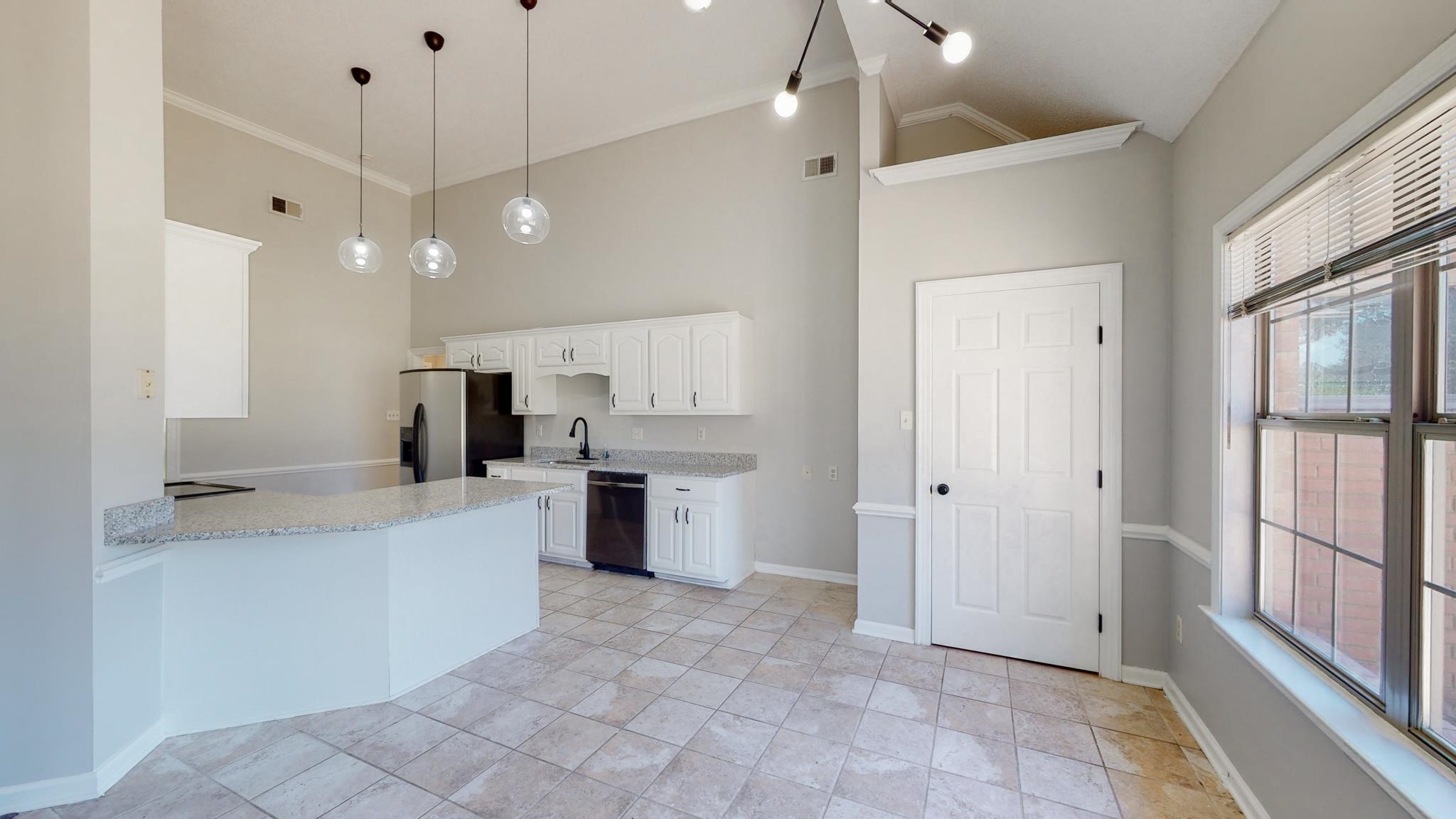 8629 Brunswick Road Millington, TN 38053 - Photo 8 of 25 a large kitchen with a refrigerator a sink and a stove