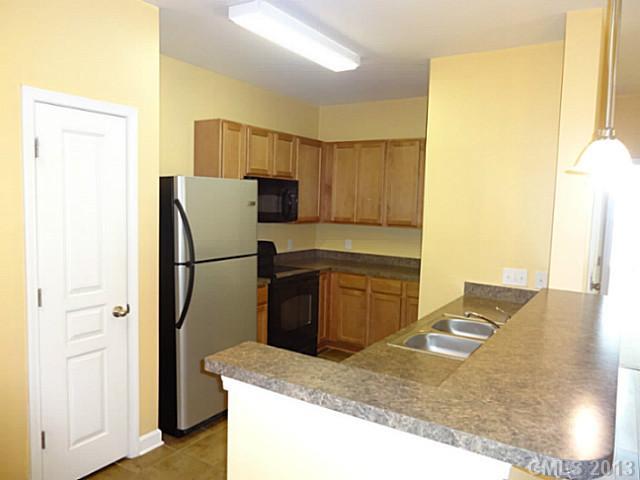 a kitchen with refrigerator and window