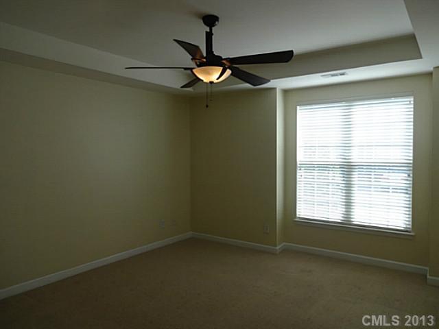 10125 Westmoreland Road, Unit IB Cornelius, NC 28031 - Photo 2 of 16 a view of an empty room with a window