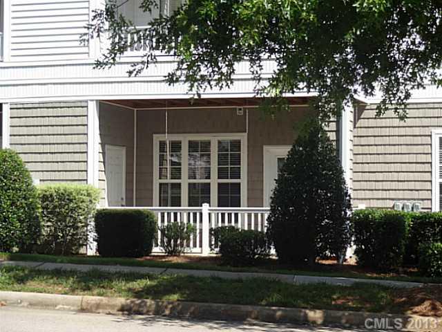 10125 Westmoreland Road, Unit IB Cornelius, NC 28031 - Photo 13 of 16 a front view of a house with a yard and garage