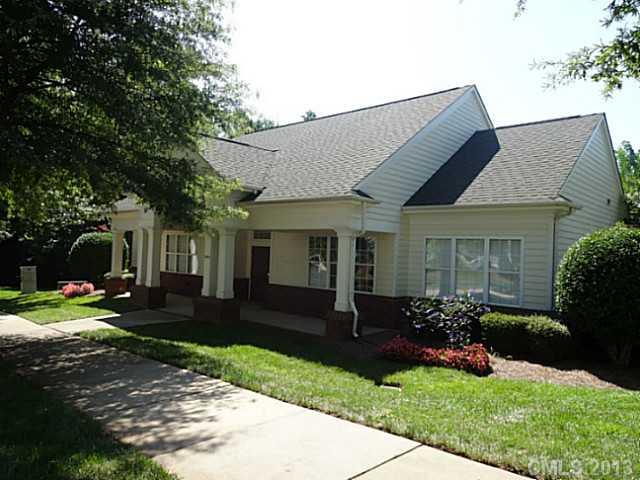 10125 Westmoreland Road, Unit IB Cornelius, NC 28031 - Photo 14 of 16 a front view of a house with a yard and porch