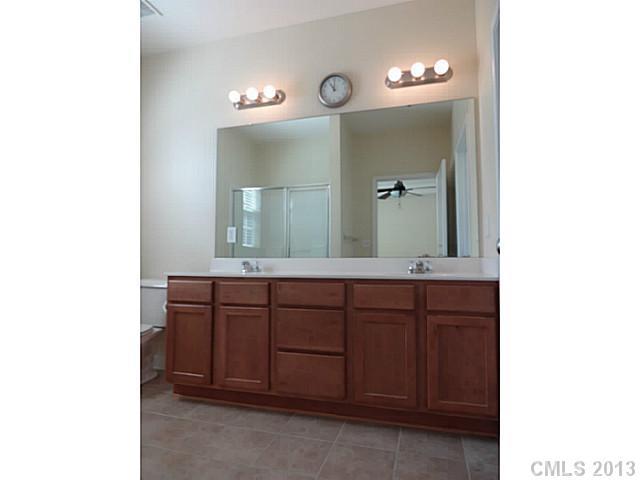 10125 Westmoreland Road, Unit IB Cornelius, NC 28031 - Photo 3 of 16 a bathroom with a sink and a mirror