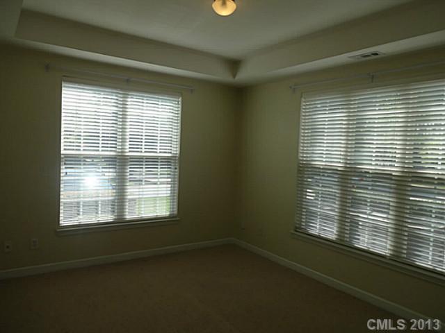 10125 Westmoreland Road, Unit IB Cornelius, NC 28031 - Photo 4 of 16 a view of an empty room with a window