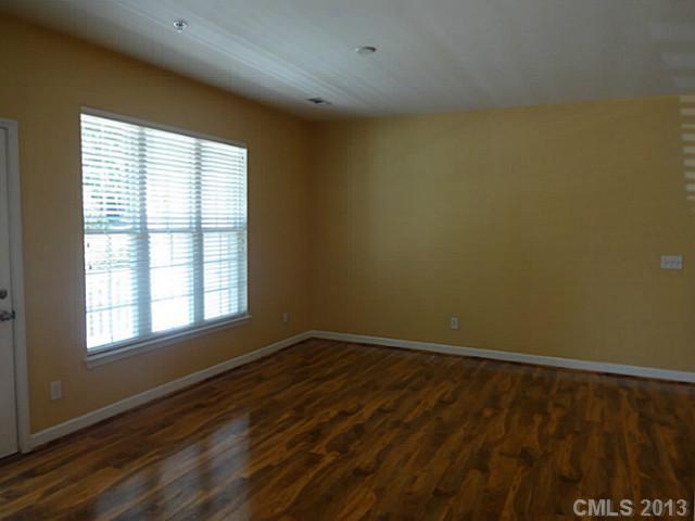 10125 Westmoreland Road, Unit IB Cornelius, NC 28031 - Photo 5 of 16 a view of an empty room with a window