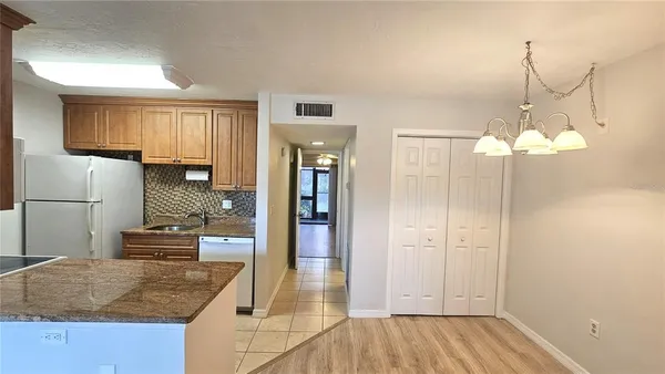a kitchen with stainless steel appliances granite countertop a sink and a stove