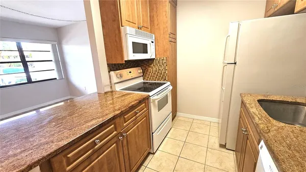 a bathroom with a granite countertop sink a vanity and a bathtub