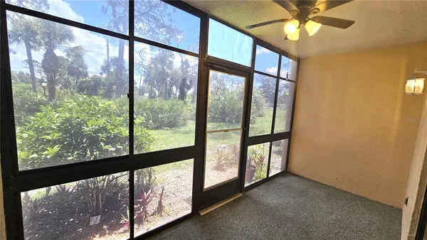 a view of an empty room and glass door