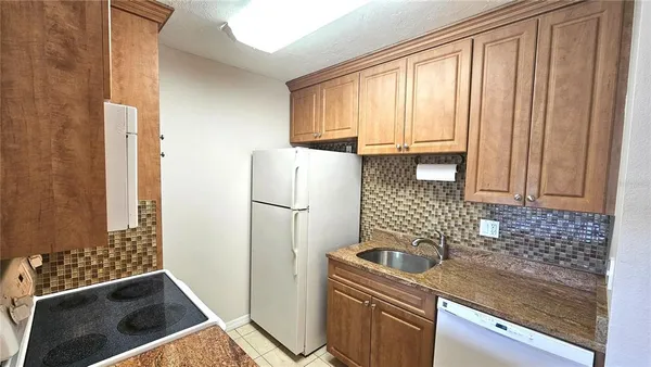 a kitchen with a refrigerator and a sink