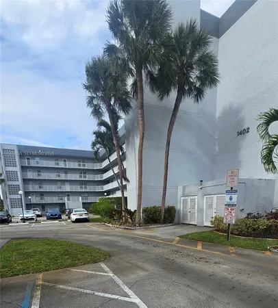 a view of a tall building next to a yard