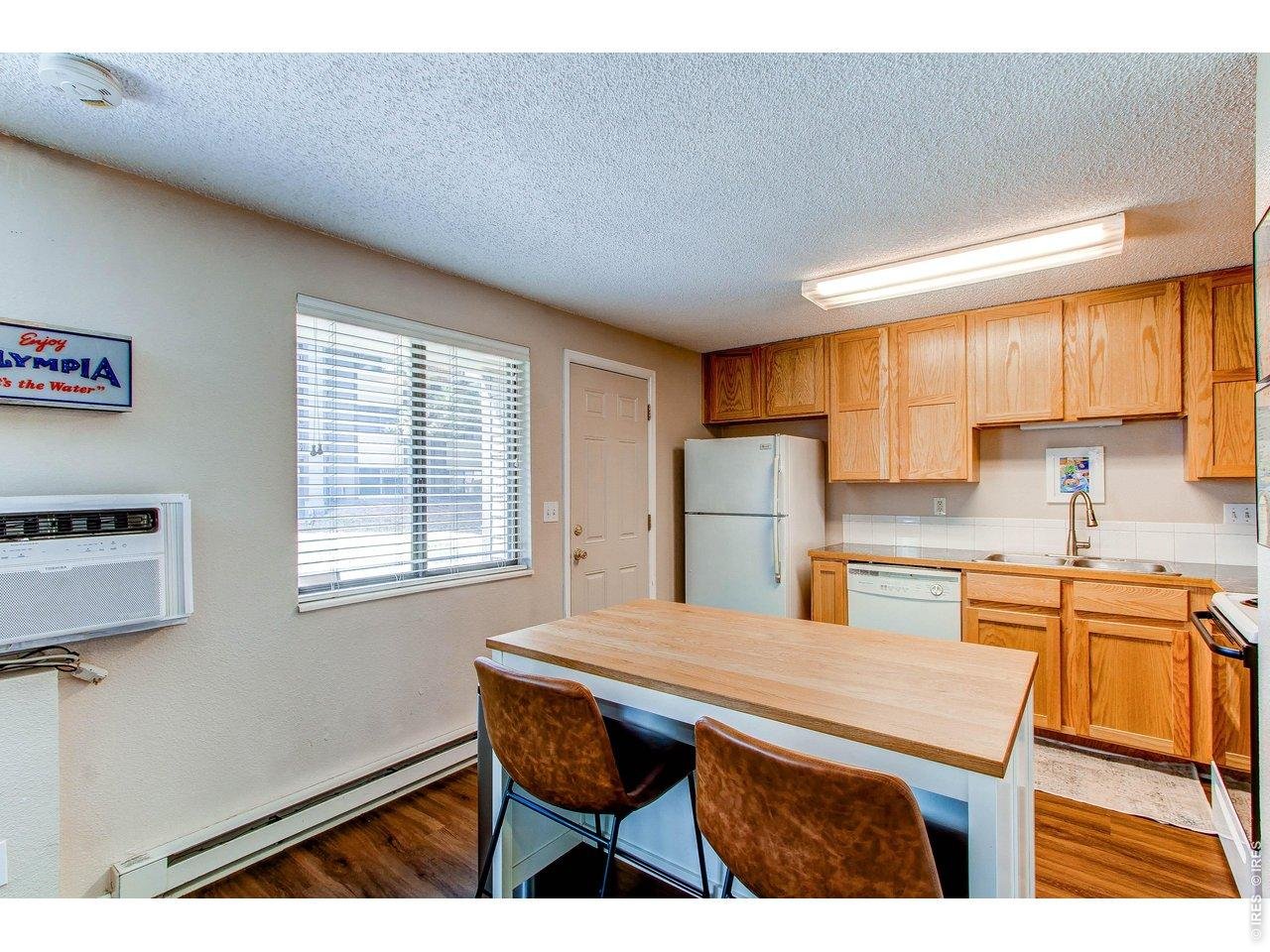925 Columbia Road, Unit 111 Fort Collins, CO 80525 - Photo 8 of 16 Kitchen with movable island and chairs