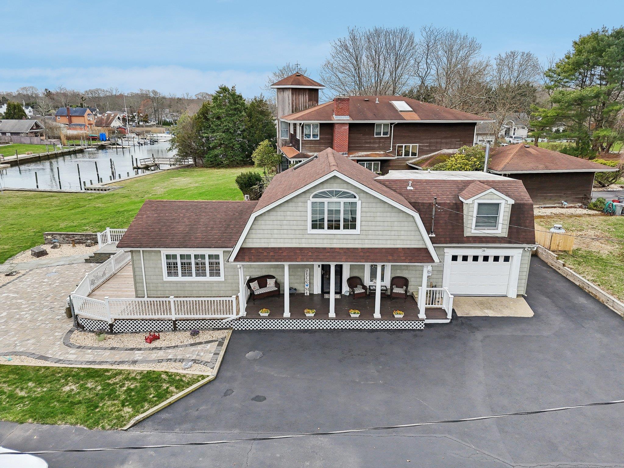 16 Red Bridge Road Center Moriches, NY 11934 - Photo 1 of 1 View of front of property with a water view, a front yard, driveway, and a gambrel roof