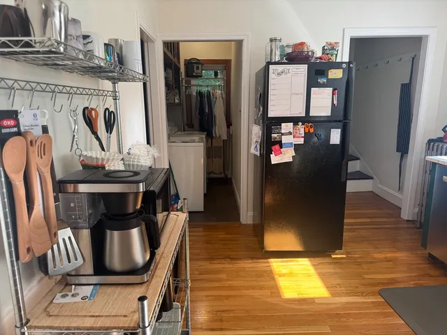 a kitchen with stainless steel appliances granite countertop a refrigerator and a stove