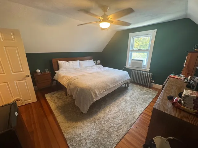 a bedroom with a bed window and a window