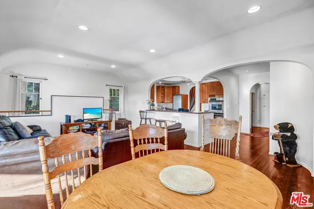 a living room with furniture a rug and white walls