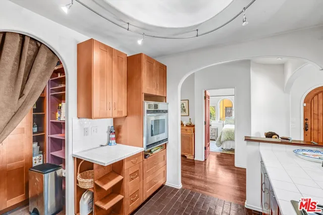 a open kitchen with stainless steel appliances granite countertop a stove and a refrigerator