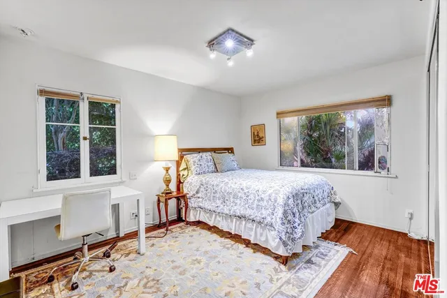 a bedroom with bed and a window