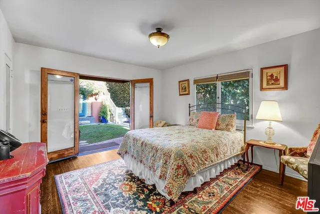 a bedroom with a bed and glass window