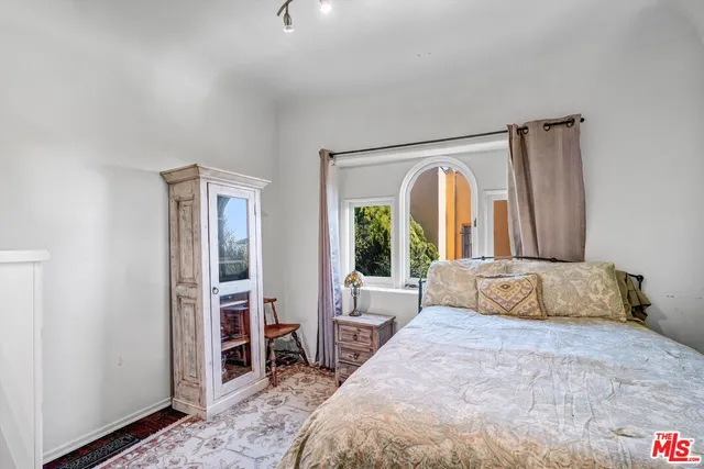 a bedroom with a large bed and a large window