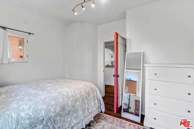 a bedroom with a bed and a dresser