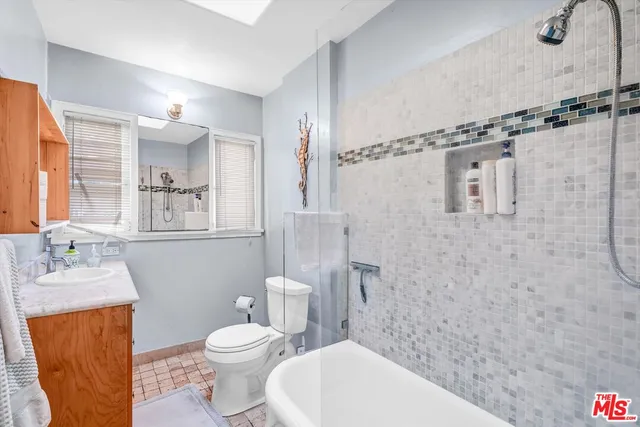 a bathroom with a toilet sink and shower