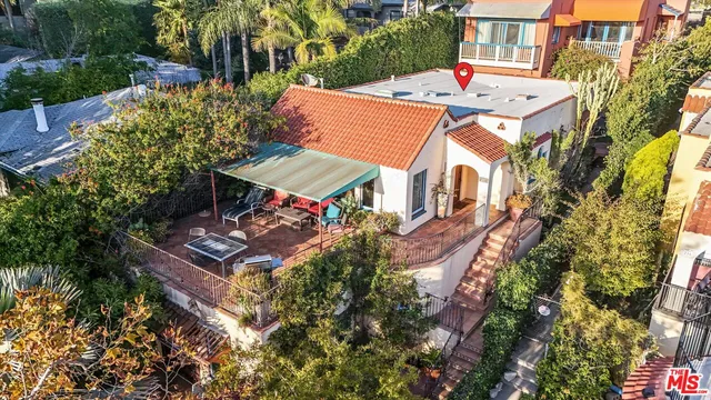 an aerial view of a house with an outdoor space