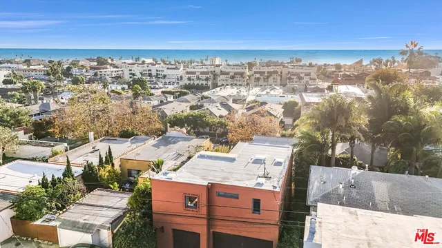 an aerial view of residential houses with city view