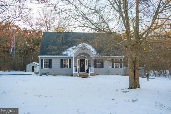a front view of a house with yard covered in snow