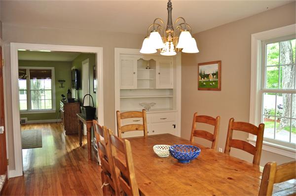 331 Goldthwaite Road Northbridge, MA 01588 - Photo 10 of 23 a dining room with wooden floor a chandelier a glass table and chairs