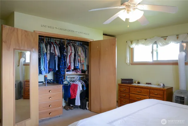 a bedroom with a bed and a mirror