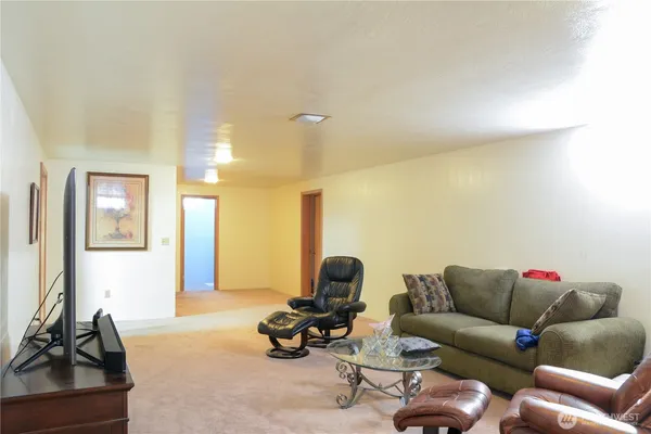 a living room with furniture and a mirror