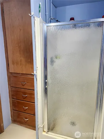 a bathroom with a shower and a tub