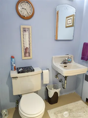 a white toilet sitting next to a bathroom sink