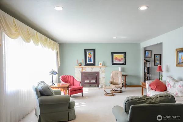 a living room with furniture and a fireplace