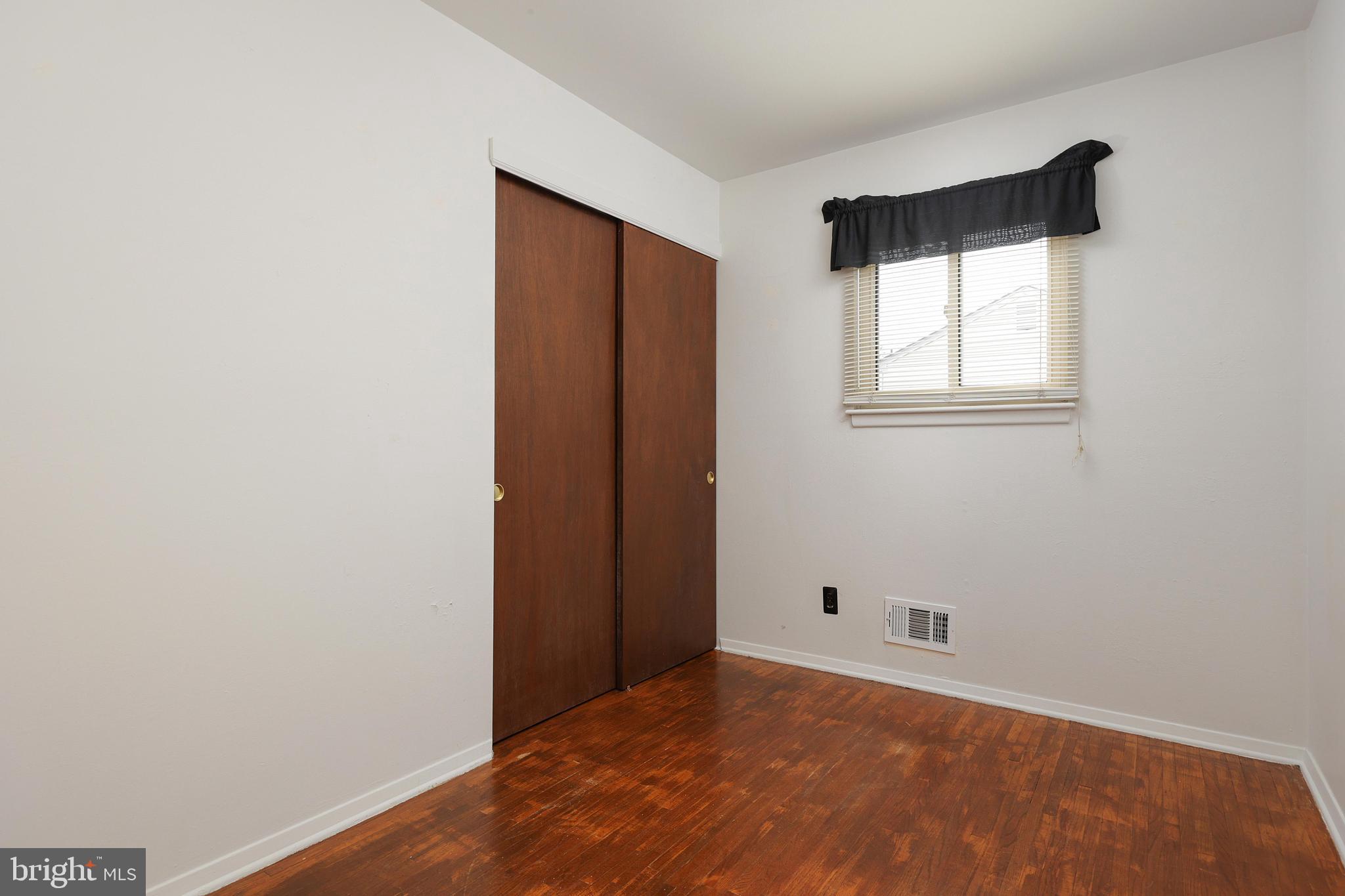 81 Falmouth Road Hamilton, NJ 08620 - Photo 14 of 26 a view of an empty room with wooden floor and a window