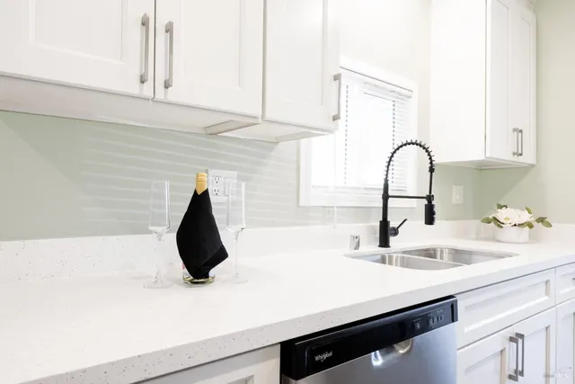 a kitchen with a sink cabinets and appliances
