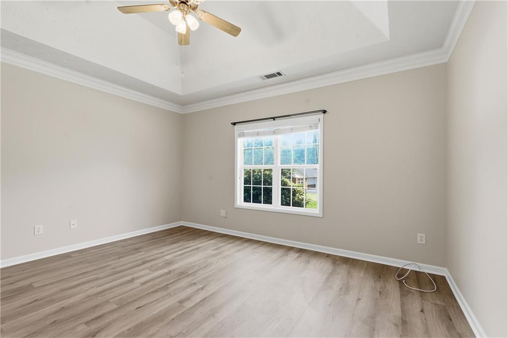 4533 Caleb Crossing, Unit 18 Powder Springs, GA 30127 - Photo 12 of 24 wooden floor in an empty room with a window