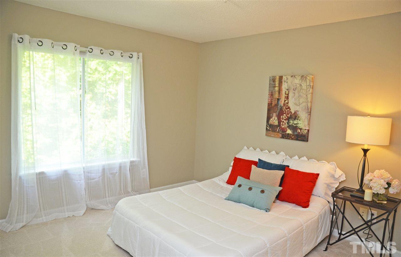 1500 Graduate Lane, Unit 204 Raleigh, NC 27606 - Photo 13 of 23 a bedroom with a bed and a lamp