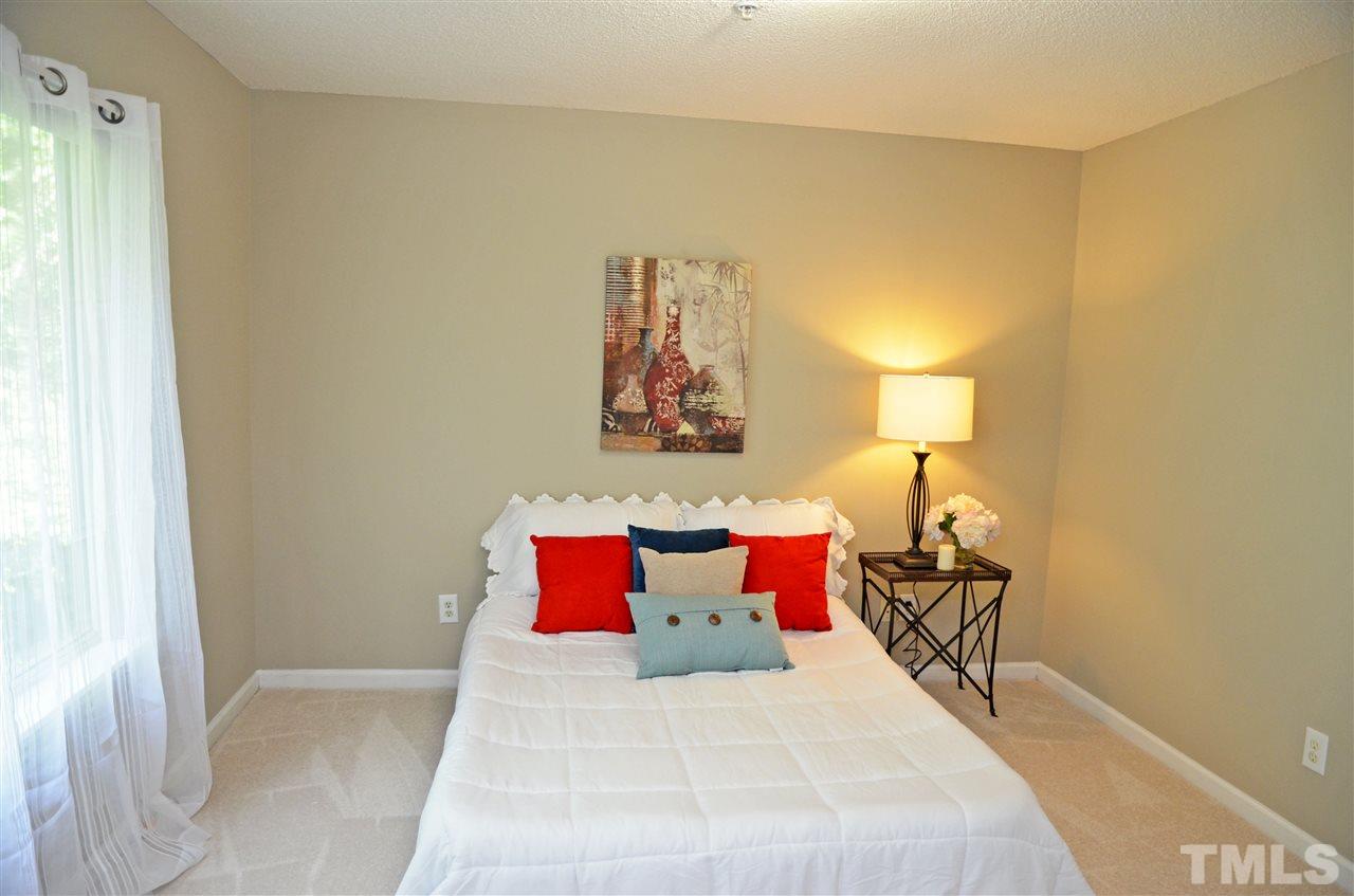 1500 Graduate Lane, Unit 204 Raleigh, NC 27606 - Photo 14 of 23 a bedroom with a bed and a painting on the wall