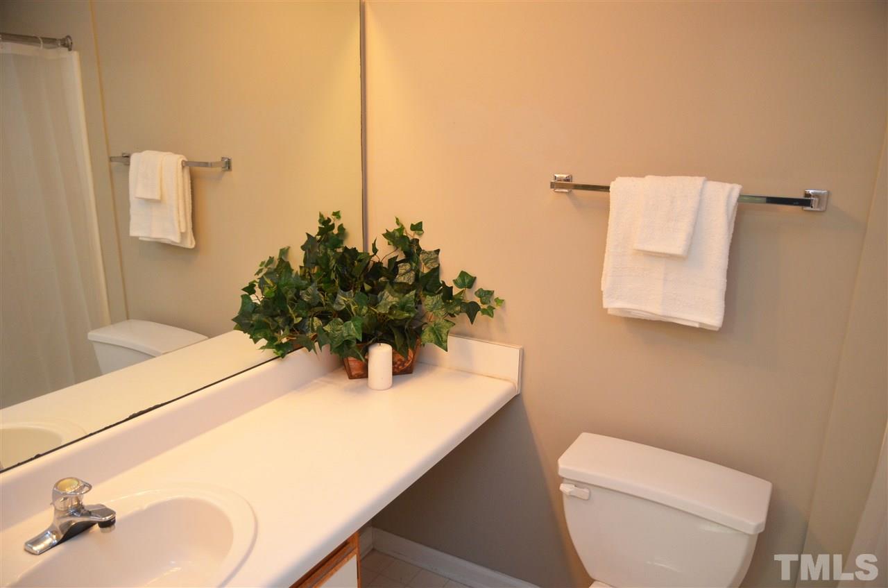 1500 Graduate Lane, Unit 204 Raleigh, NC 27606 - Photo 16 of 23 a bathroom with a sink a toilet and mirror