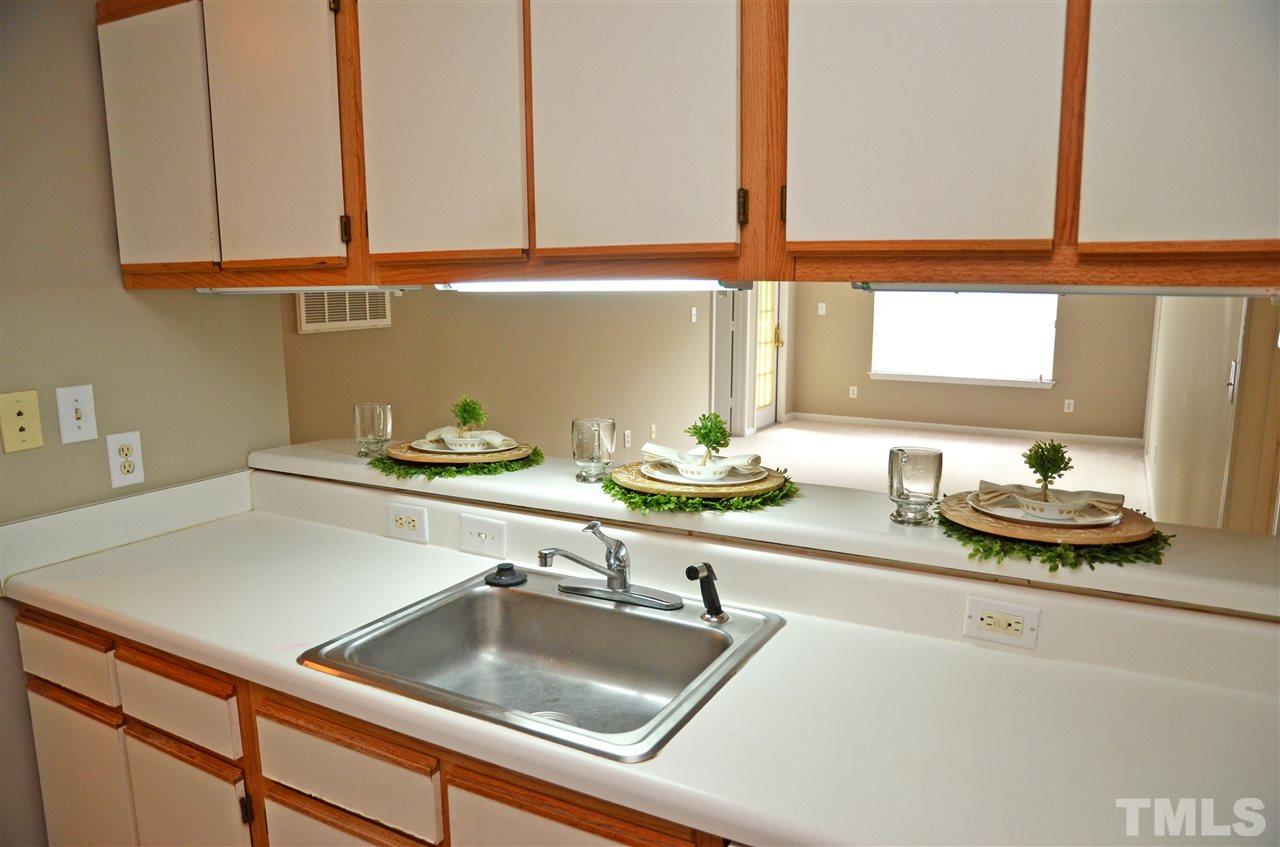 1500 Graduate Lane, Unit 204 Raleigh, NC 27606 - Photo 8 of 23 a kitchen with a sink and a stove top oven