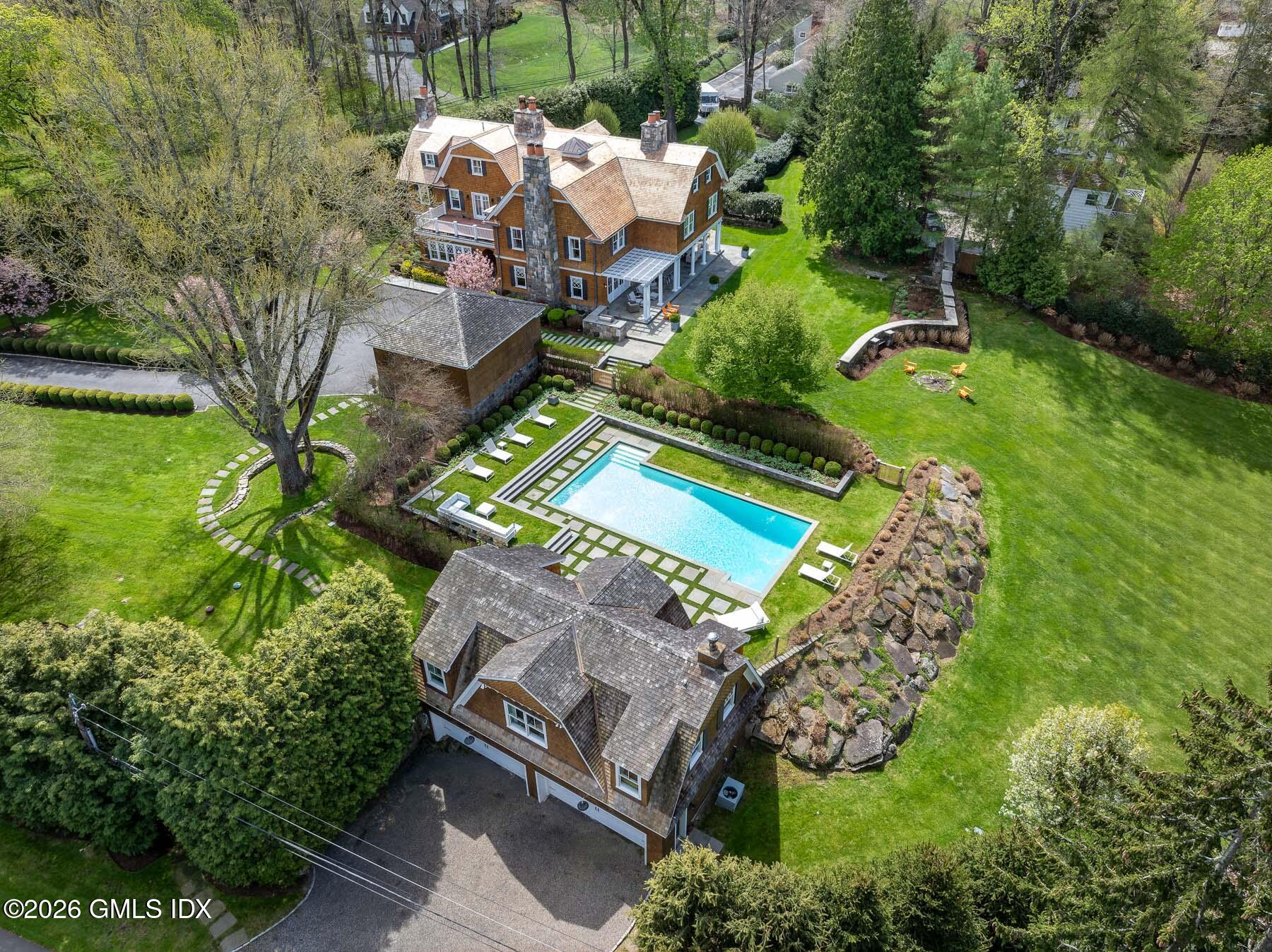 212 Bedford Road Greenwich, CT 06831 - Photo 4 of 39 an aerial view of a house with a garden and trees