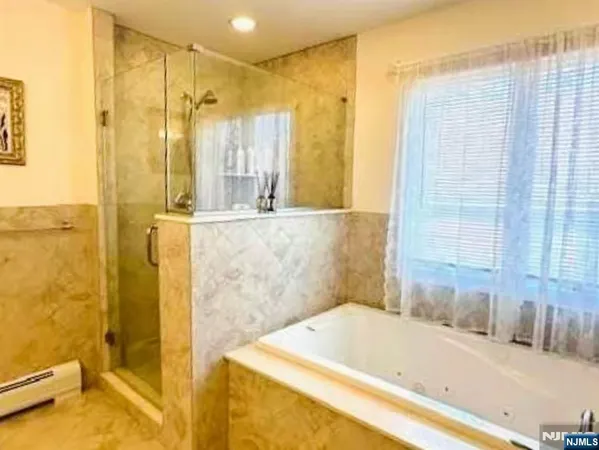 a bathroom with a tub and shower