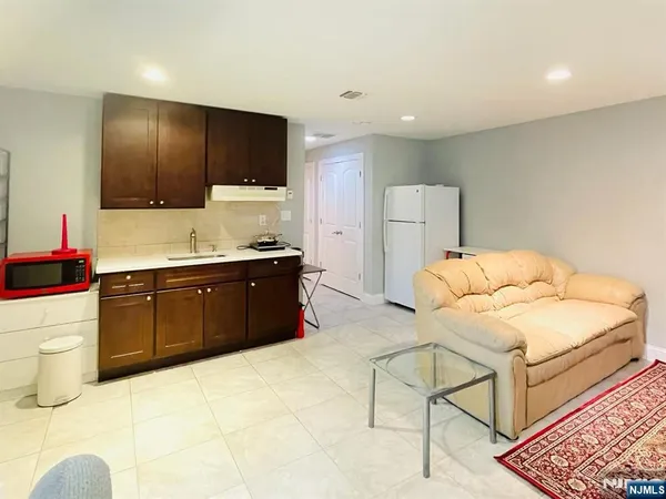a spacious bathroom with a granite countertop sink and a mirror