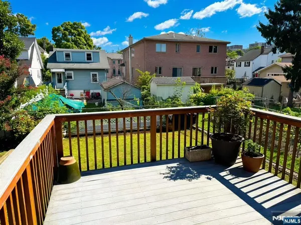 a view of a street with wooden fence