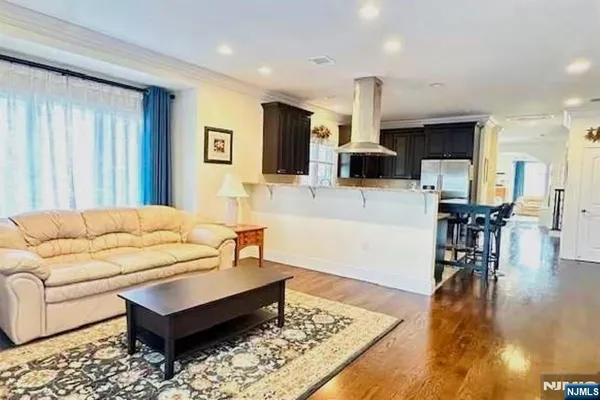 a living room with furniture rug and wooden floor