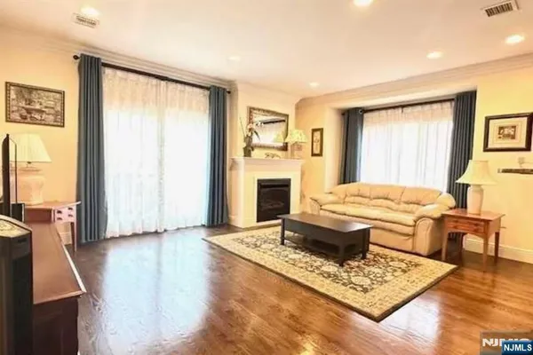 a living room with fireplace furniture and a table