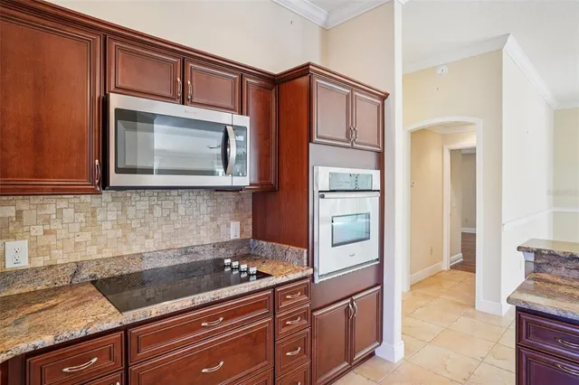 a kitchen with granite countertop cabinets and steel stainless steel appliances