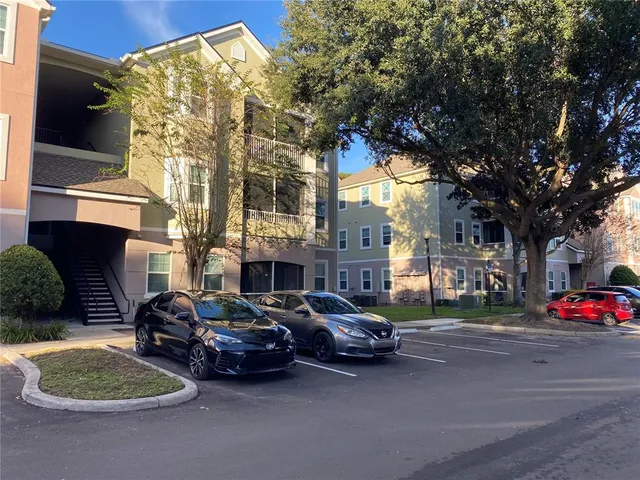 a couple of cars parked in front of a house