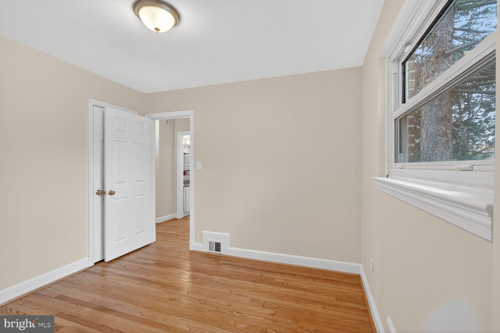 4503 Woodfield Road Kensington, MD 20895 - Photo 8 of 30 Bright and airy room with hardwood floors.