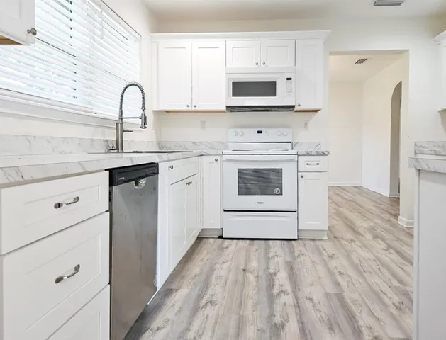 a kitchen with a refrigerator and cabinets